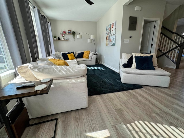 living room with ceiling fan and light wood-type flooring