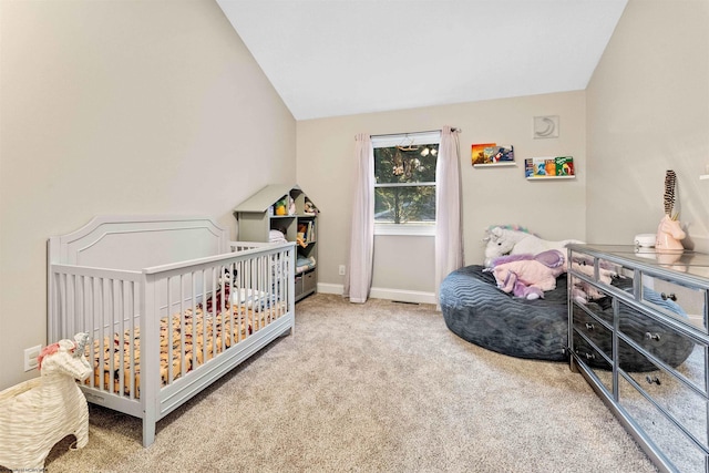 carpeted bedroom with vaulted ceiling and baseboards