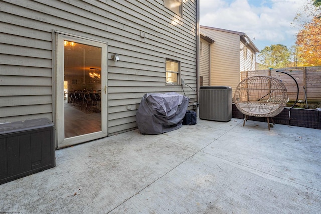 view of patio with fence and cooling unit