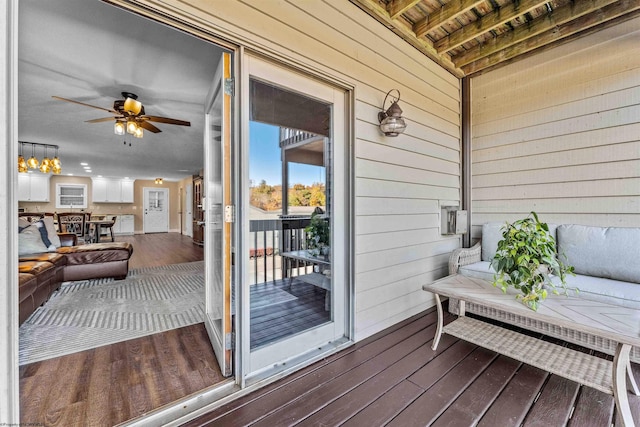 wooden deck with a ceiling fan