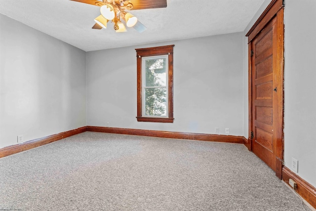 empty room with a textured ceiling, carpet floors, and ceiling fan