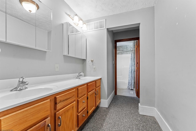 bathroom featuring vanity and a textured ceiling