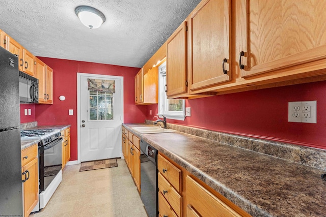 kitchen featuring a textured ceiling, black appliances, and sink