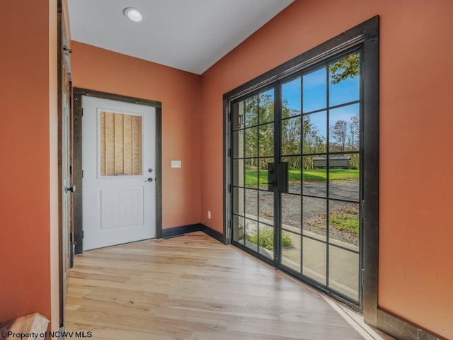 doorway to outside with light hardwood / wood-style floors