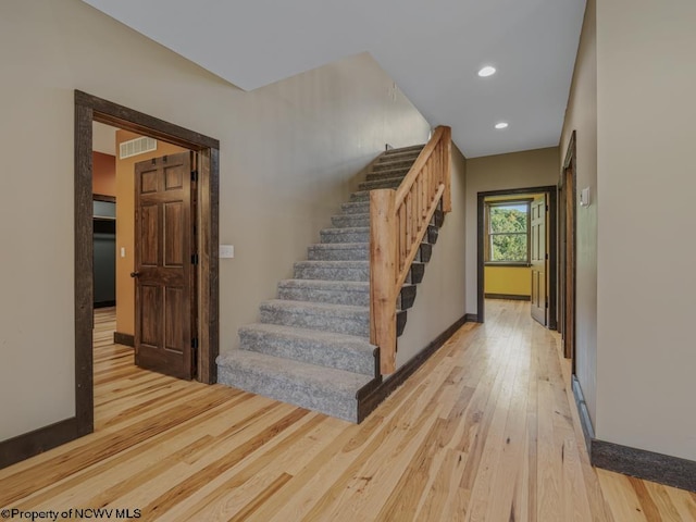 stairs featuring wood-type flooring