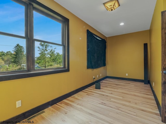 unfurnished room featuring light hardwood / wood-style floors