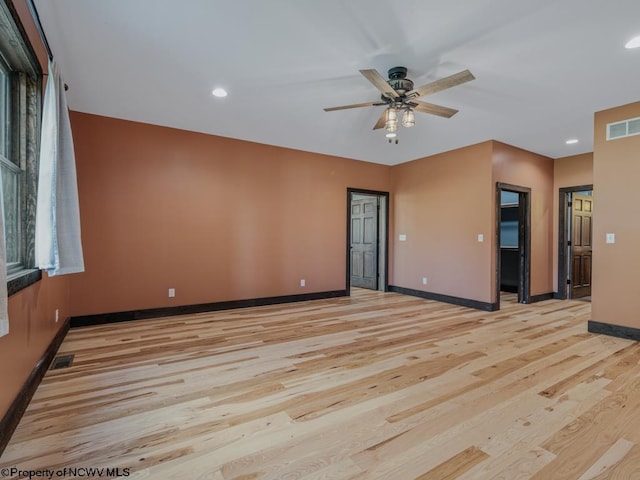 spare room with ceiling fan and light wood-type flooring