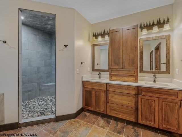 bathroom with vanity and tiled shower