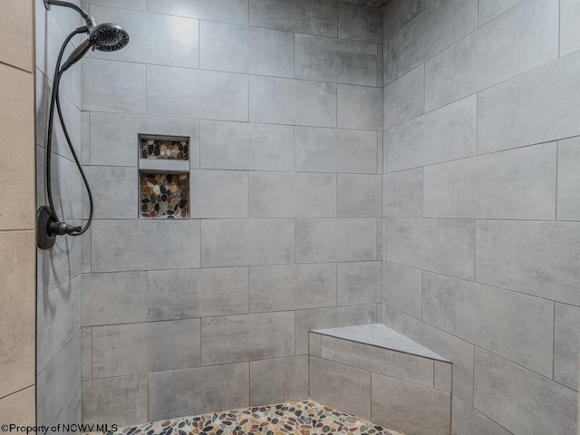 bathroom featuring a tile shower