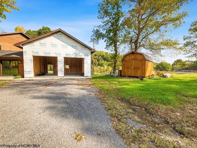 view of front of property with a front yard and a storage unit