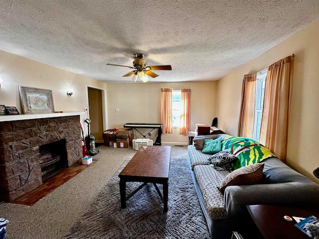 living room with carpet floors, a textured ceiling, a fireplace, and ceiling fan