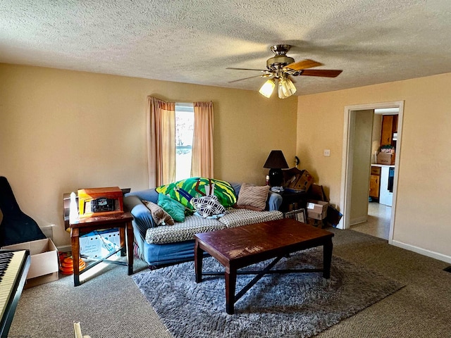 carpeted living room with a textured ceiling and ceiling fan