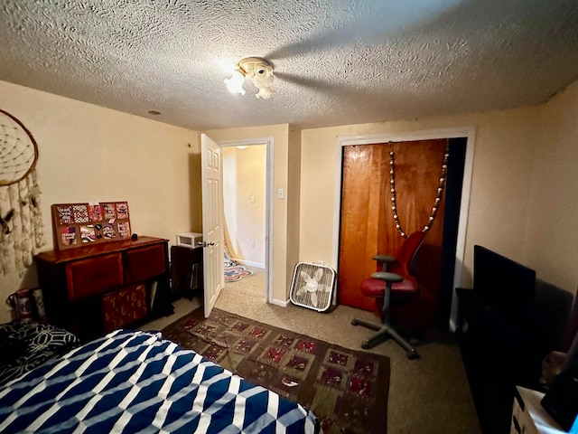 bedroom with carpet flooring and a textured ceiling