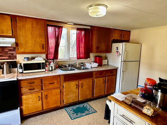 kitchen featuring sink, white appliances, and extractor fan