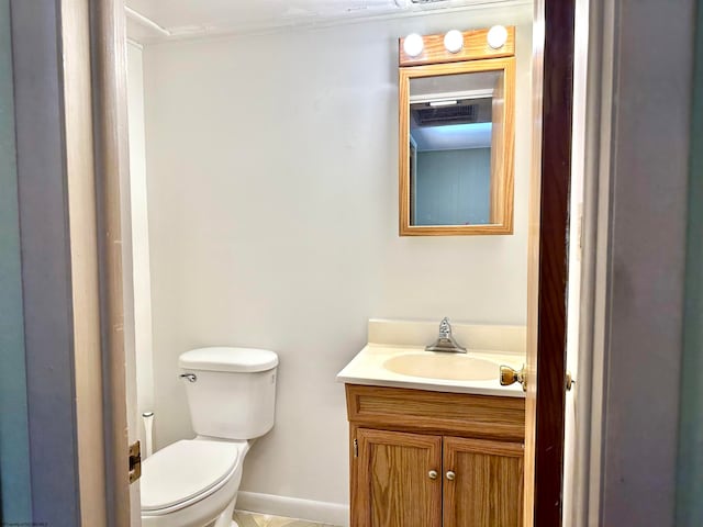 bathroom featuring toilet and vanity