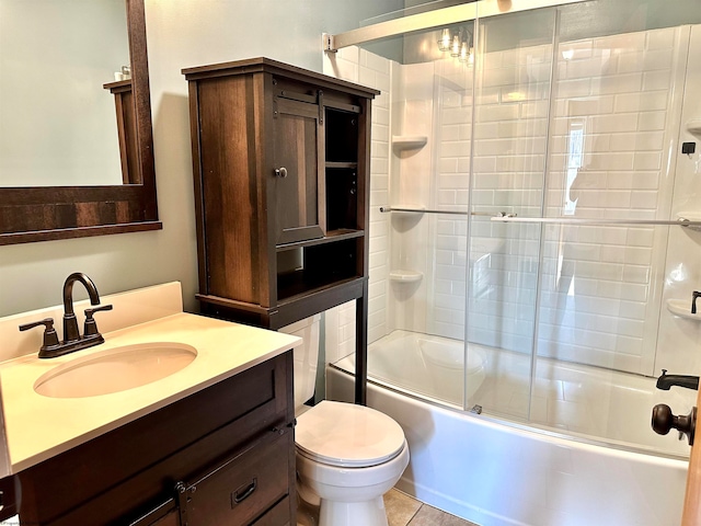 full bathroom with vanity, enclosed tub / shower combo, toilet, and tile patterned floors