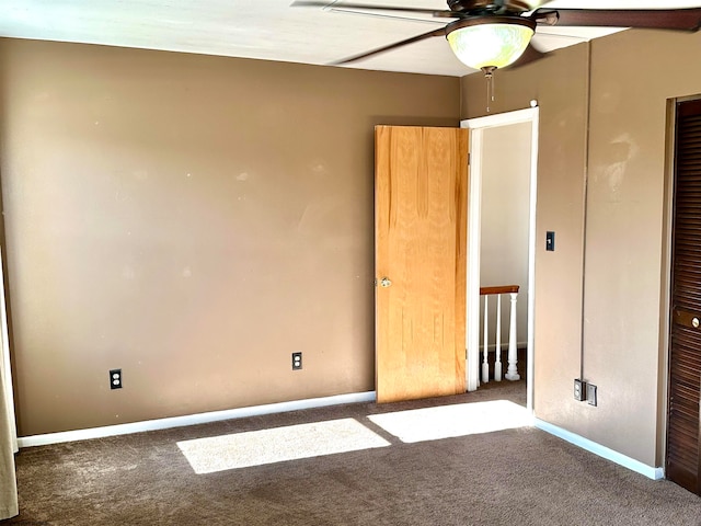 unfurnished bedroom featuring dark colored carpet, a closet, and ceiling fan