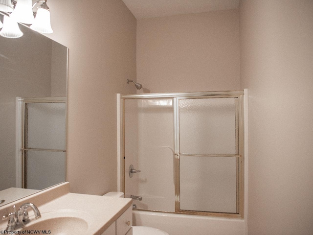 full bathroom with vanity, toilet, and shower / bath combination with glass door