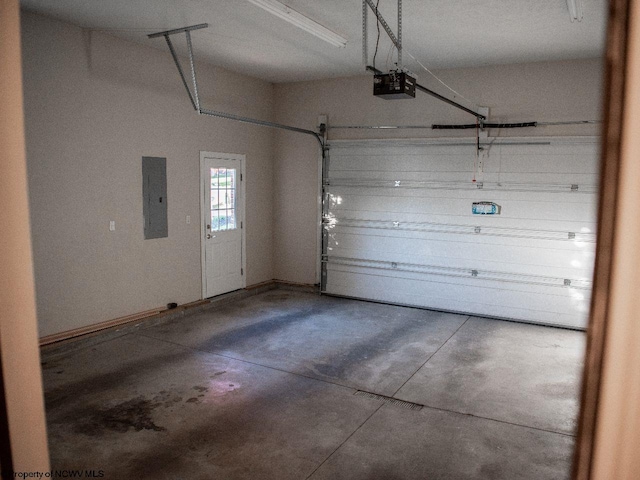 garage featuring electric panel and a garage door opener