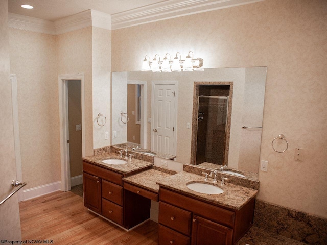 bathroom featuring vanity, crown molding, hardwood / wood-style flooring, and an enclosed shower