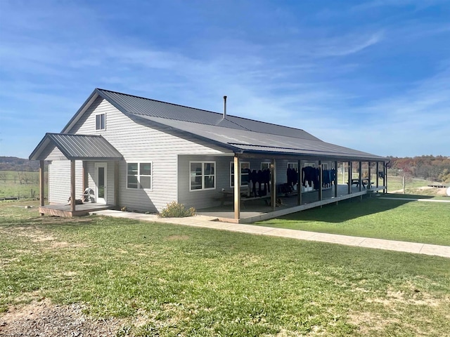 back of house featuring a patio and a lawn