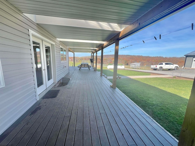 wooden terrace with french doors and a lawn