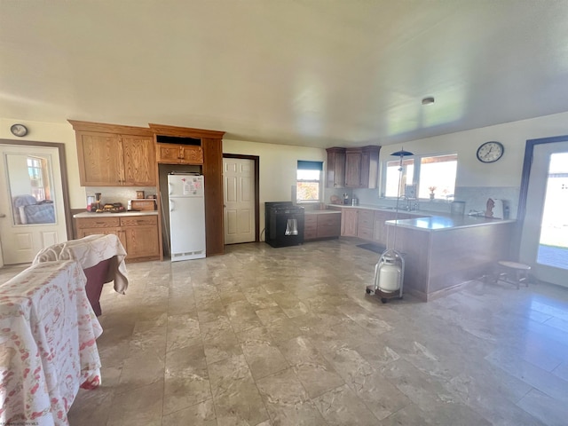 kitchen with white fridge and kitchen peninsula