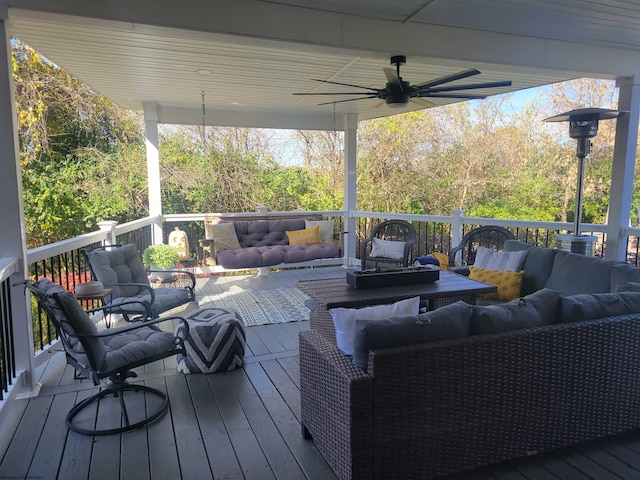 wooden terrace featuring outdoor lounge area and ceiling fan