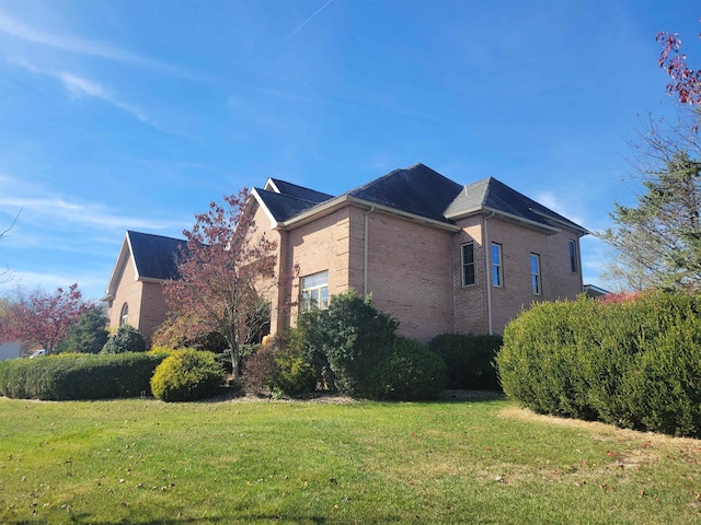 view of home's exterior with a yard