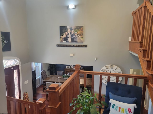 interior space featuring a towering ceiling and hardwood / wood-style flooring