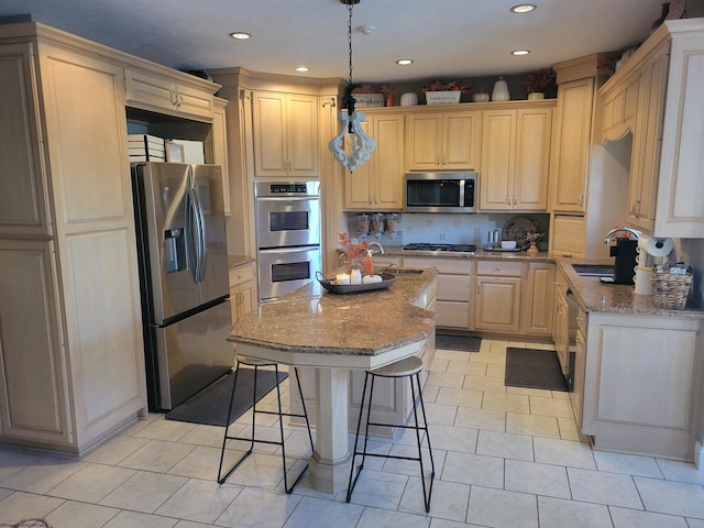 kitchen featuring a kitchen bar, an island with sink, stainless steel appliances, pendant lighting, and light stone counters