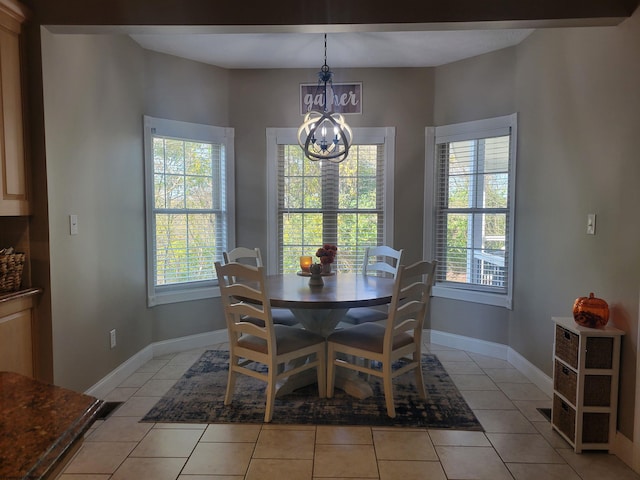 tiled dining area with an inviting chandelier