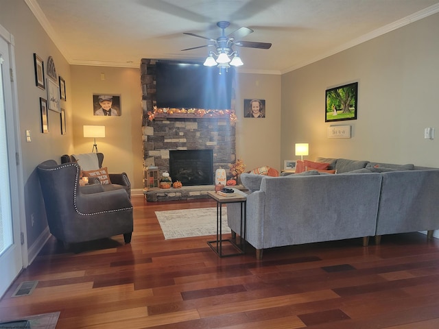 living room with ornamental molding, dark wood-type flooring, a fireplace, and ceiling fan