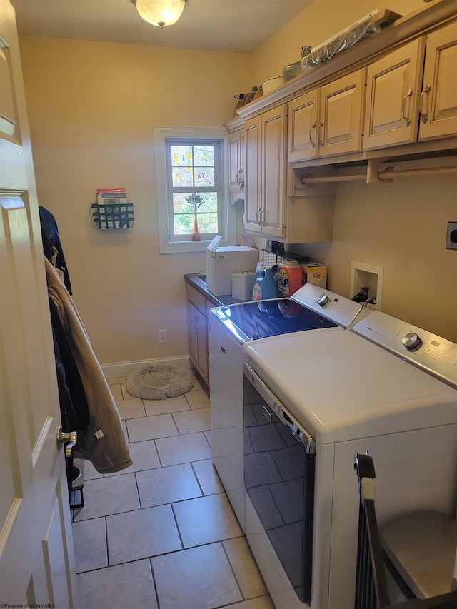 washroom featuring light tile patterned flooring, cabinets, and separate washer and dryer