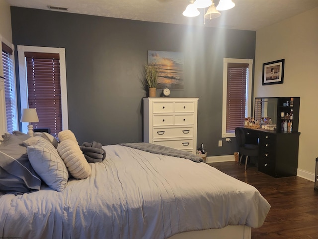 bedroom with ceiling fan and dark hardwood / wood-style floors