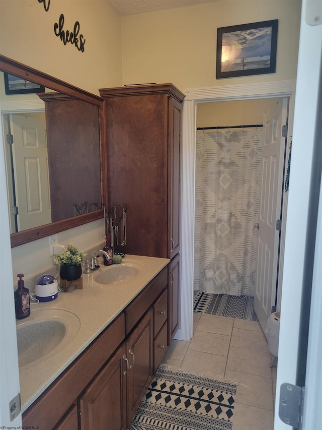 bathroom with vanity, toilet, and tile patterned floors