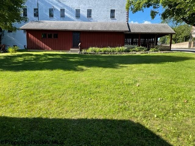 rear view of house with a lawn