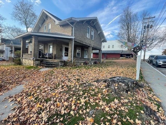 view of side of home with covered porch