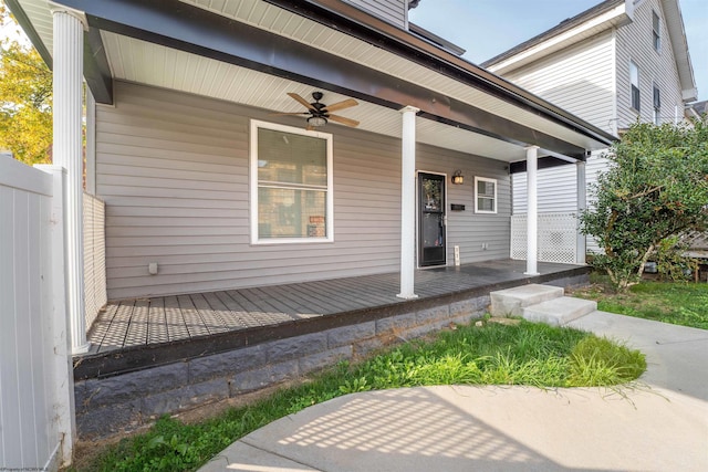 view of exterior entry featuring covered porch and ceiling fan