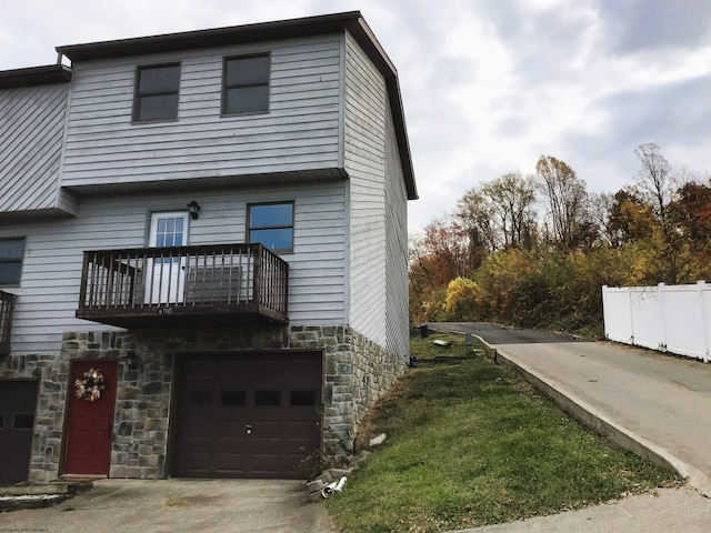 view of front of home with a garage and a balcony