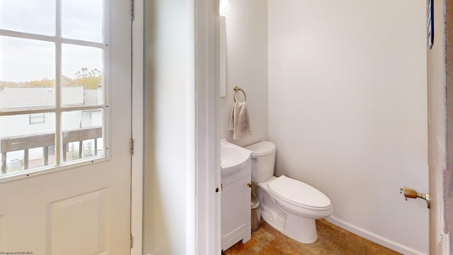 bathroom with toilet, a healthy amount of sunlight, and vanity