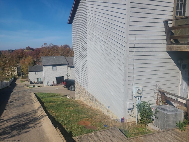 view of home's exterior with a patio area and cooling unit