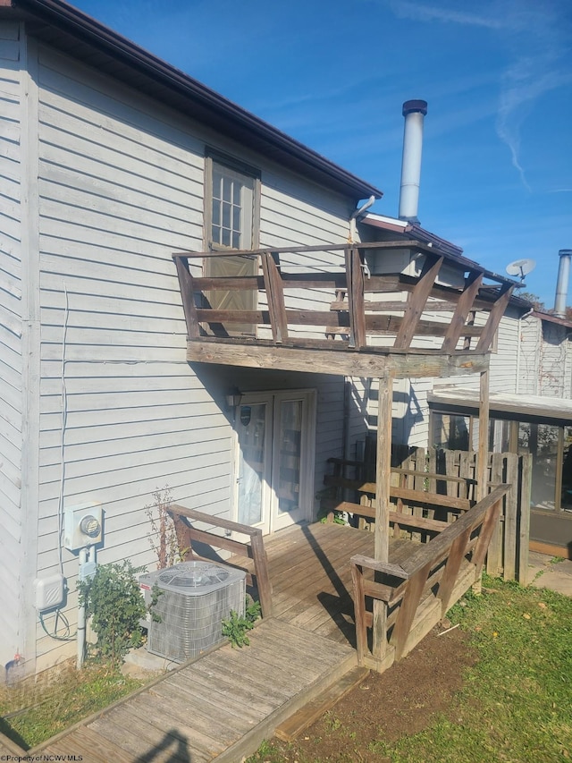 wooden terrace featuring central air condition unit and a pergola