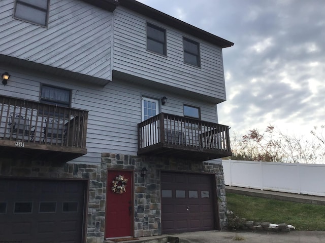 exterior space with a garage and a balcony