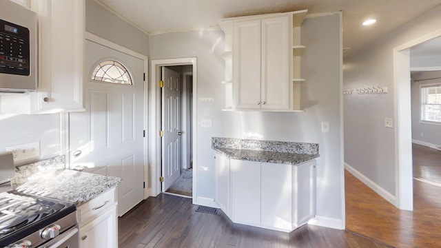 kitchen featuring appliances with stainless steel finishes, white cabinetry, and dark hardwood / wood-style floors