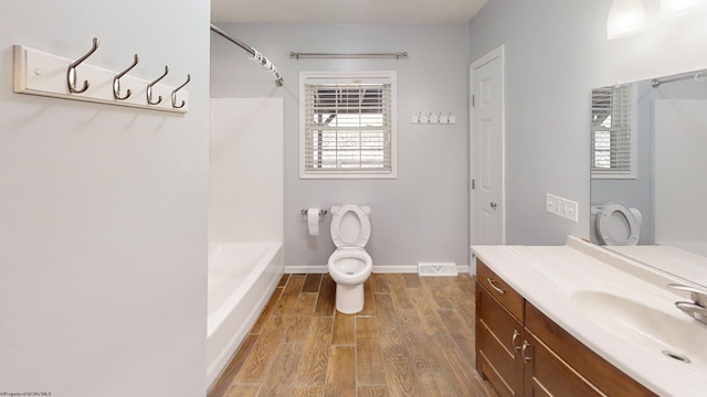 full bathroom with vanity, toilet, shower / bathing tub combination, and wood-type flooring