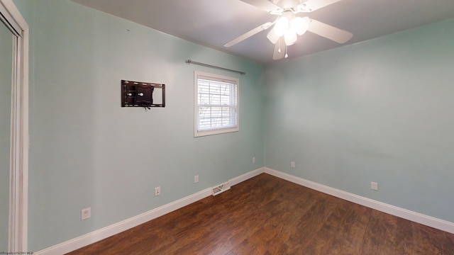 spare room featuring ceiling fan and dark hardwood / wood-style flooring