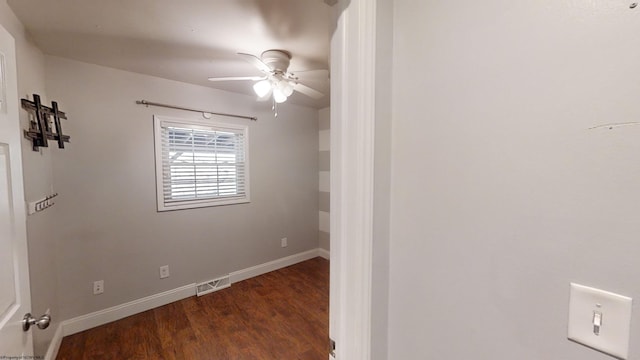 spare room with ceiling fan and dark hardwood / wood-style floors