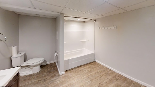 full bathroom featuring bathtub / shower combination, toilet, a paneled ceiling, vanity, and hardwood / wood-style flooring