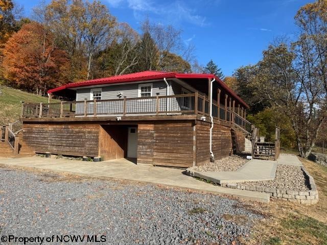 front of property with a wooden deck